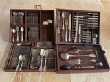 a wooden box with silverware in it on the floor