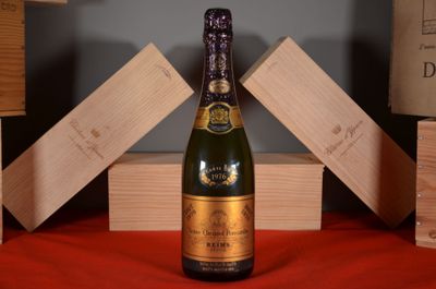 a bottle of champagne sitting on a red table cloth