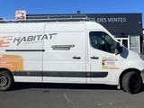 a white van that is parked in front of a building