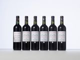 six bottles of wine are lined up on a table