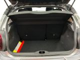 the back of a car with the trunk open and a yellow marker in the trunk