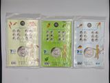 four different types of coins in plastic bags on a white surface