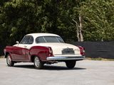 a red and white car that is parked in a parking lot