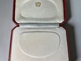 a small box with a ring inside of it on a table