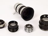 a lot of different types of camera lenses on the table