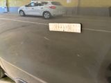 a sticker on the hood of a car in a parking garage