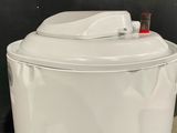 a white toilet that has a red button on it