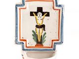 a picture of a ceramic crucifix hanging on a wall