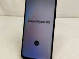 a close up of a phone on a table with the text xiaomi hyperos on it