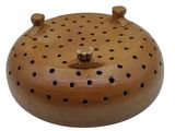 a small wooden object with holes on it