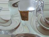 two clear glass vases sitting on a wooden table
