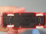 a person holding a red and black remote control