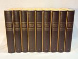 six books in a row on a white surface