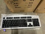a keyboard that is sitting on the ground in front of a box