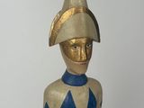 a wooden statue of a man with a hat on his head