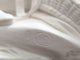 a white statue of a horse that is sitting on a table