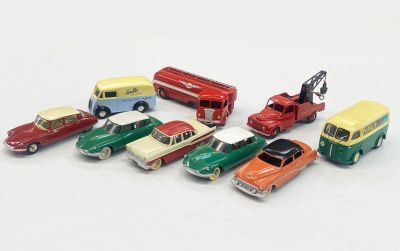 a lot of toy cars that are on a white surface