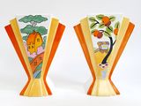 two vases that have been painted with oranges on them