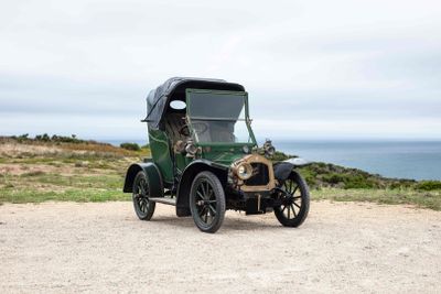 a old car that is parked on the side of the road