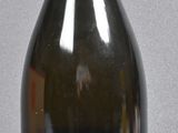 a bottle with a label on it sitting on a table