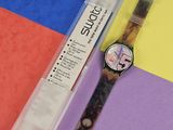 une montre posée sur une surface colorée