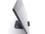 a laptop that is sitting on a stand on a white surface