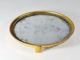 an image of a gold plate with a mirror in the middle of it