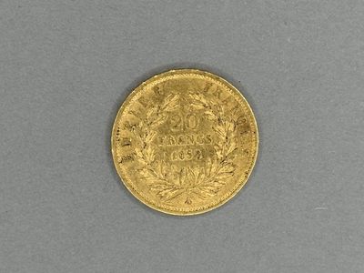 a close up of a gold coin on a gray surface