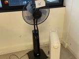 a fan sitting in front of a window in a room