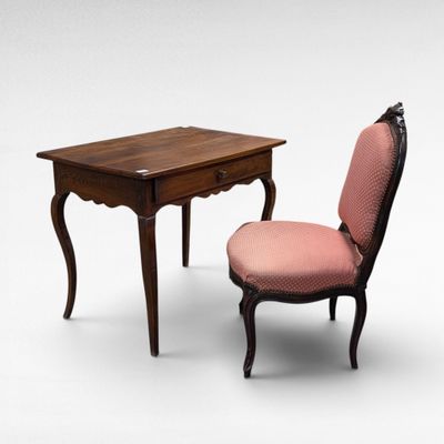 a small table with a chair next to it on a white background