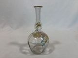 a glass vase with a flower inside of it