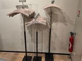 three clothes hangers on the floor in a room