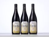 three bottles of wine sitting on top of a table next to each other