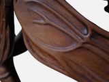 a close up of a wooden bench with a bird on it