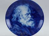 a blue and white plate with an image of a bearded man