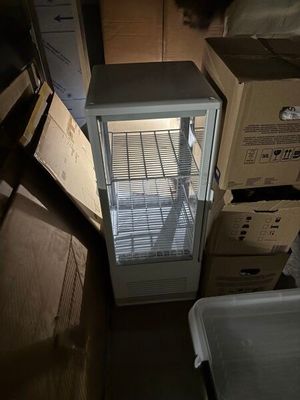 a refrigerator that is sitting in the middle of a room