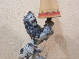a blue and white statue of a rooster with a lamp on a table