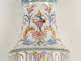 a large vase that has a bird on top of it