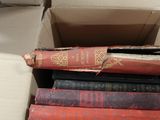 a box full of old books sitting on a table