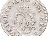 a silver coin with a crown on top of it