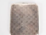silver cigarette case with a checkered pattern on the front