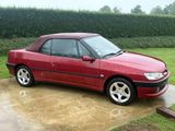 a picture of a red car parked in a driveway