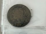 an old coin in a plastic bag on a table