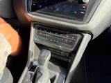 a stuffed animal sitting in the driver ' s seat of a car