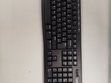 a computer keyboard and mouse on a white desk