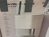 packaging of a white microwave sitting on top of a cardboard box