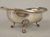 a silver bowl with a fish on it on a stand
