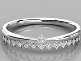 a close up of a diamond ring on a reflective surface