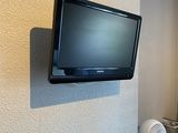 a flat screen tv mounted on the wall in a small room