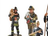 five figurines of firemen standing on a white surface